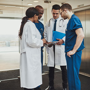 Picture of two Physicians ( male and female) and two Nurses (both males).